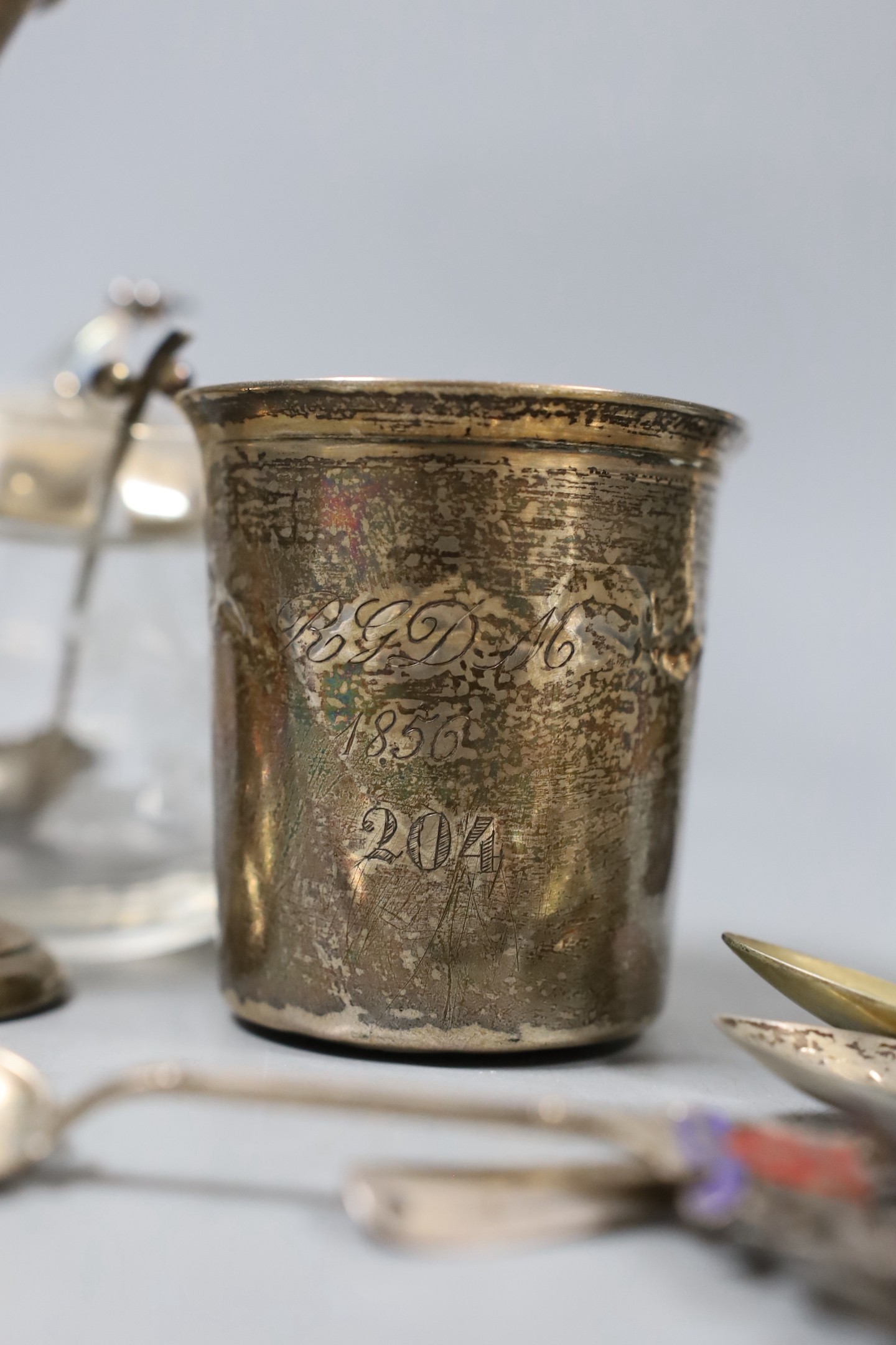 A collection of eighteen small pieces of silver and white metal items, including a silver topped glass preserve jar, trophy cup, flatware, napkin ring, trinket box, etc.